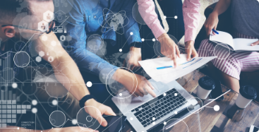 Group of professionals gathered around laptop